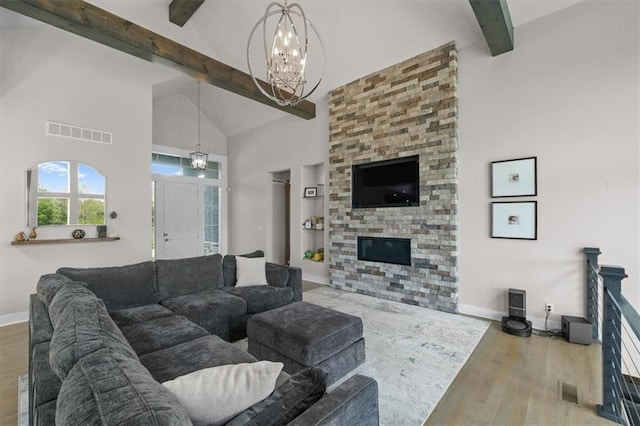 10523 N Dalton Ave, Kansas City, MO 64154 - living room featuring a chandelier, beam ceiling, wood finished floors, high vaulted ceiling, and baseboards
