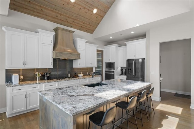 10523 N Dalton Ave, Kansas City, MO 64154 - kitchen with stainless steel appliances, a sink, custom range hood, white cabinets, and wooden ceiling