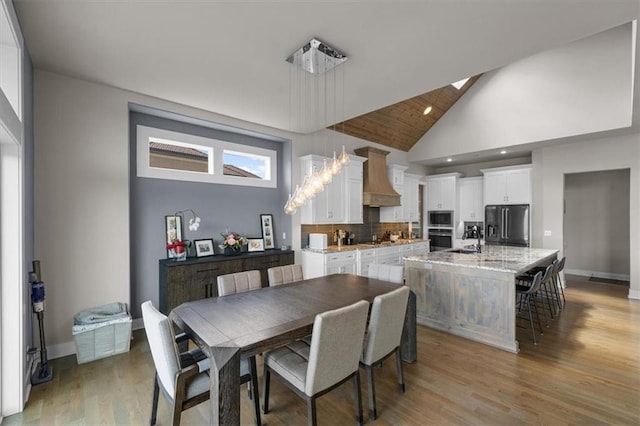 10523 N Dalton Ave, Kansas City, MO 64154 - dining space with high vaulted ceiling, light wood-style floors, baseboards, and recessed lighting