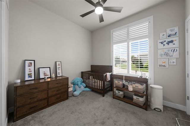 10523 N Dalton Ave, Kansas City, MO 64154 - carpeted bedroom with a crib, ceiling fan, and baseboards