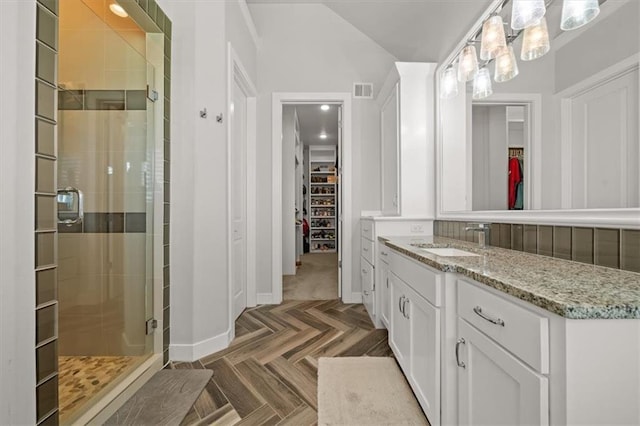 10523 N Dalton Ave, Kansas City, MO 64154 - full bath with a shower stall, a walk in closet, baseboards, and vanity