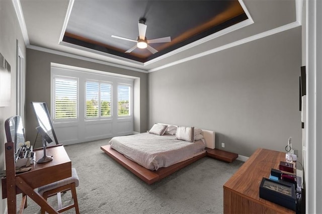 10523 N Dalton Ave, Kansas City, MO 64154 - carpeted bedroom featuring a raised ceiling, ornamental molding, and ceiling fan