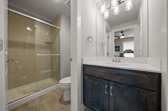 10523 N Dalton Ave, Kansas City, MO 64154 - full bathroom with toilet, ensuite bathroom, a shower stall, vanity, and a ceiling fan