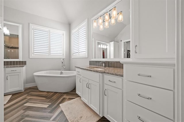 10523 N Dalton Ave, Kansas City, MO 64154 - bathroom with lofted ceiling, vanity, a freestanding tub, and a shower