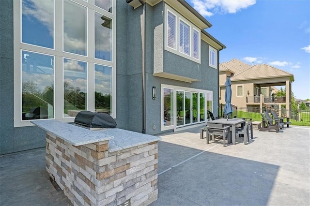 10523 N Dalton Ave, Kansas City, MO 64154 - rear view of property featuring area for grilling, a patio, fence, outdoor dining space, and stucco siding