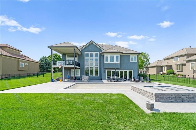 10523 N Dalton Ave, Kansas City, MO 64154 - back of property with a balcony, a patio area, stucco siding, and a pool with connected hot tub