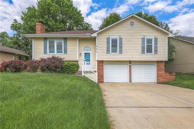 1620 NE Misty Ln, Lees Summit, MO 64086 - bi-level home featuring brick siding, a chimney, a garage, and concrete driveway