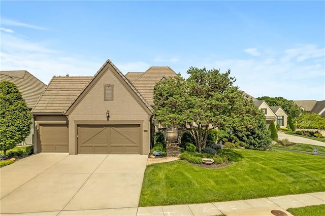 15201 Catalina St, Leawood, KS 66224 - view of front facade with driveway, a front yard, a garage, a tiled roof, and stucco siding