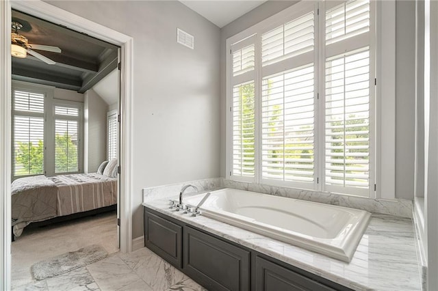 15201 Catalina St, Leawood, KS 66224 - ensuite bathroom featuring a bath, marble finish floors, and a ceiling fan