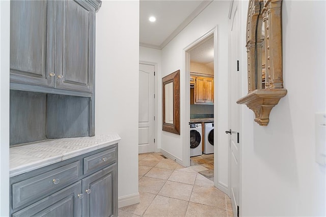 15201 Catalina St, Leawood, KS 66224 - corridor with washer and clothes dryer, ornamental molding, baseboards, light tile patterned floors, and recessed lighting