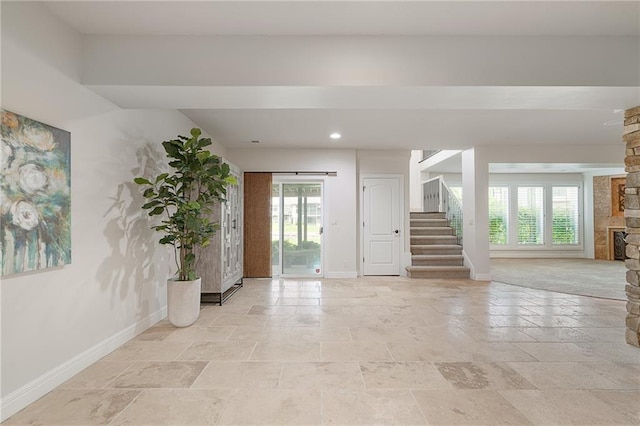15201 Catalina St, Leawood, KS 66224 - foyer with baseboards, stone tile floors, healthy amount of natural light, and stairs