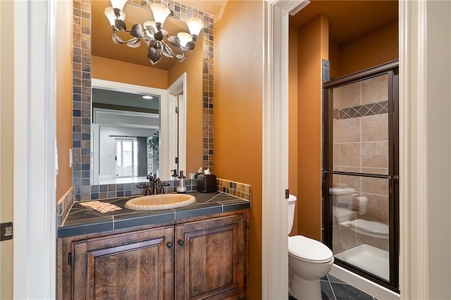 15201 Catalina St, Leawood, KS 66224 - bathroom with a chandelier, a stall shower, toilet, and vanity