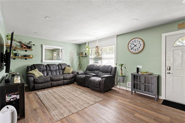 201 N Cleveland Ave, Belton, MO 64012 - living area with a textured ceiling and wood finished floors