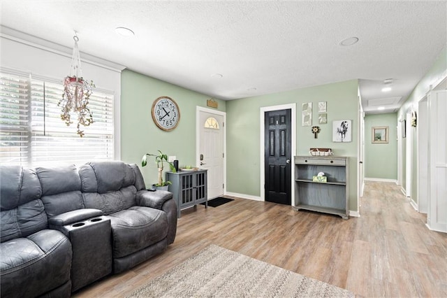 201 N Cleveland Ave, Belton, MO 64012 - living area with a textured ceiling, light wood-style flooring, baseboards, and recessed lighting