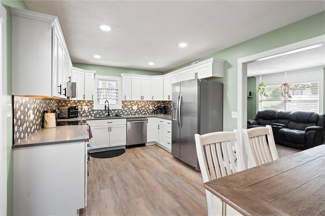 201 N Cleveland Ave, Belton, MO 64012 - kitchen with stainless steel appliances, a sink, plenty of natural light, light wood-style floors, and recessed lighting