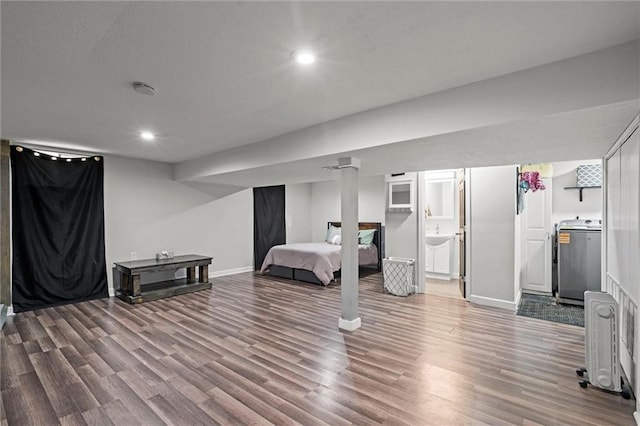 201 N Cleveland Ave, Belton, MO 64012 - bedroom featuring washer / clothes dryer, wood finished floors, recessed lighting, baseboards, and connected bathroom