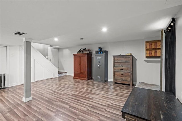 201 N Cleveland Ave, Belton, MO 64012 - finished basement featuring light wood-type flooring, radiator, recessed lighting, baseboards, and stairs