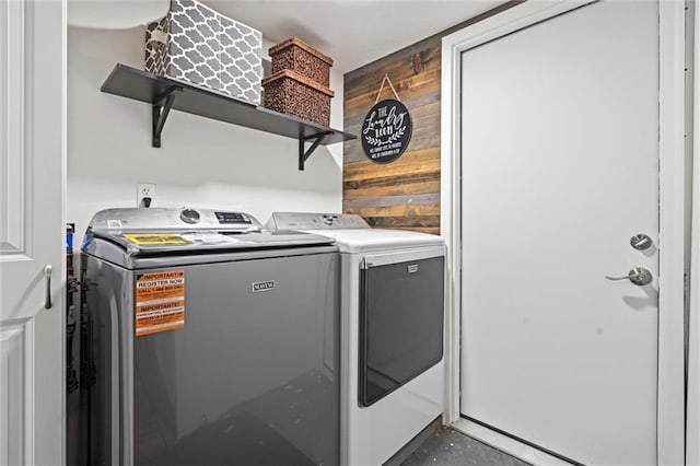 201 N Cleveland Ave, Belton, MO 64012 - washroom featuring washing machine and dryer and wooden walls