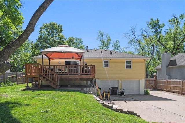 201 N Cleveland Ave, Belton, MO 64012 - back of house with stairway, a garage, a gazebo, driveway, and a wooden deck