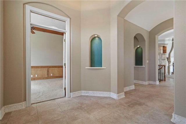 4704 W 152nd St, Leawood, KS 66224 - hallway with carpet flooring and arched walkways