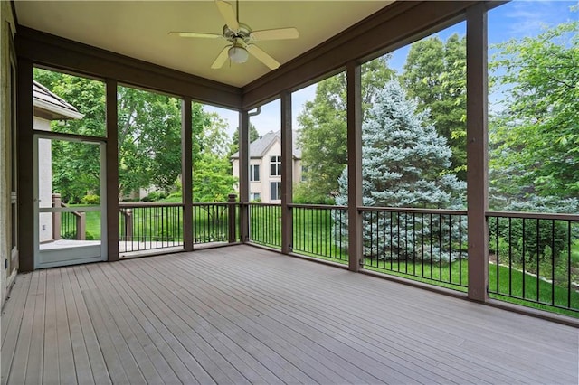 4704 W 152nd St, Leawood, KS 66224 - unfurnished sunroom featuring a ceiling fan, hardwood / wood-style floors, a wooden deck, and view of wooded area