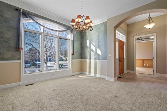 4704 W 152nd St, Leawood, KS 66224 - unfurnished dining area featuring carpet flooring, arched walkways, plenty of natural light, ornamental molding, and a chandelier