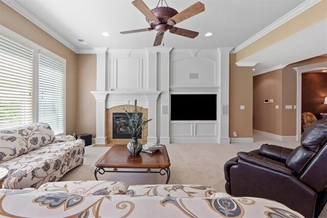 21211 E 34th St S, Independence, MO 64057 - living area with a fireplace, ornamental molding, light carpet, baseboards, and ceiling fan