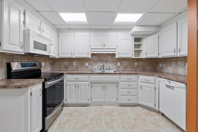 21211 E 34th St S, Independence, MO 64057 - kitchen with white appliances, a drop ceiling, white cabinets, tasteful backsplash, and light tile patterned floors