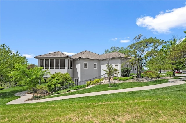 21211 E 34th St S, Independence, MO 64057 - view of side of home with stucco siding and a yard
