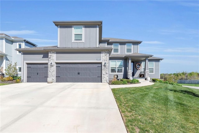 16951 S Hunter St, Olathe, KS 66062 - view of front of property with a front lawn, driveway, board and batten siding, and a garage