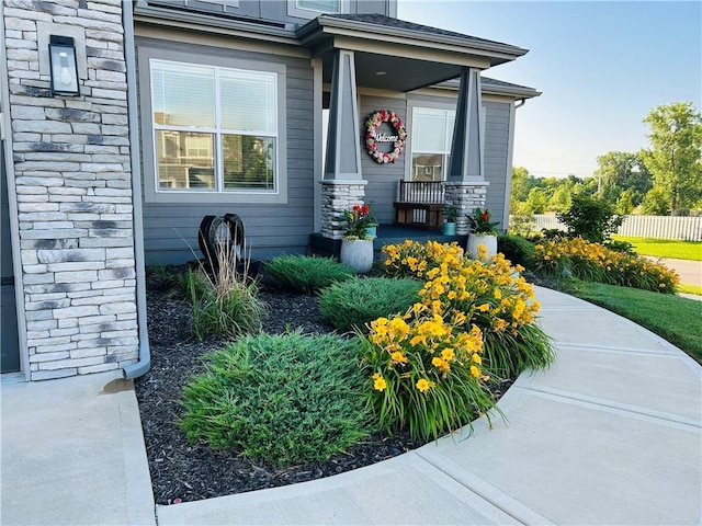 16951 S Hunter St, Olathe, KS 66062 - view of exterior entry featuring stone siding and a porch