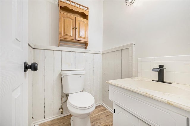1917 N Concord Rd, Independence, MO 64058 - bathroom featuring vanity, wood finished floors, and wainscoting