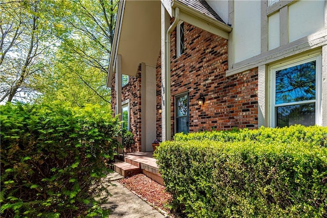 view of side of home with brick siding and stucco siding