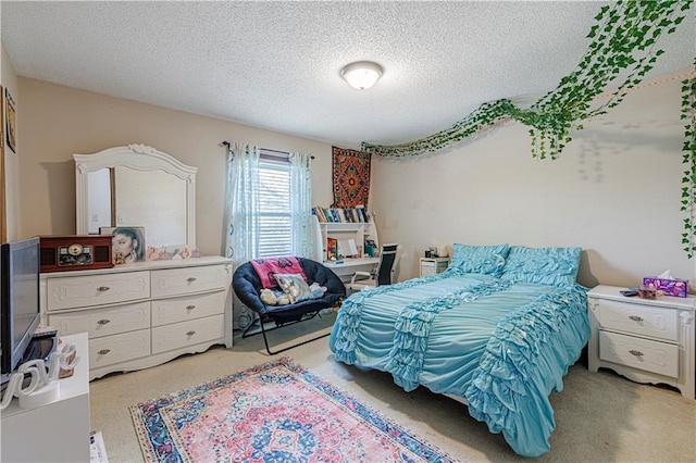 bedroom with light colored carpet and a textured ceiling