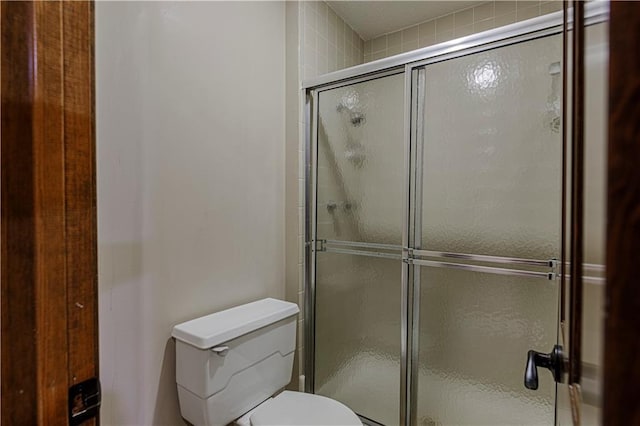 full bath with a shower stall and toilet