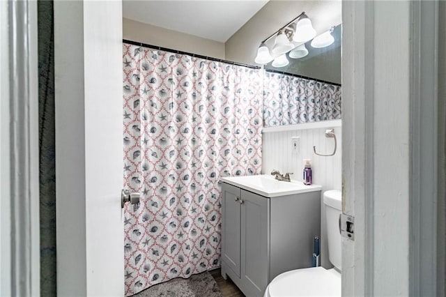 1007 Vest Dr, Warrensburg, MO 64093 - bathroom featuring toilet, vanity, wood finished floors, and a shower with shower curtain