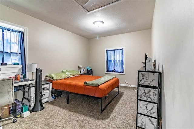 1007 Vest Dr, Warrensburg, MO 64093 - carpeted bedroom with a textured ceiling and baseboards