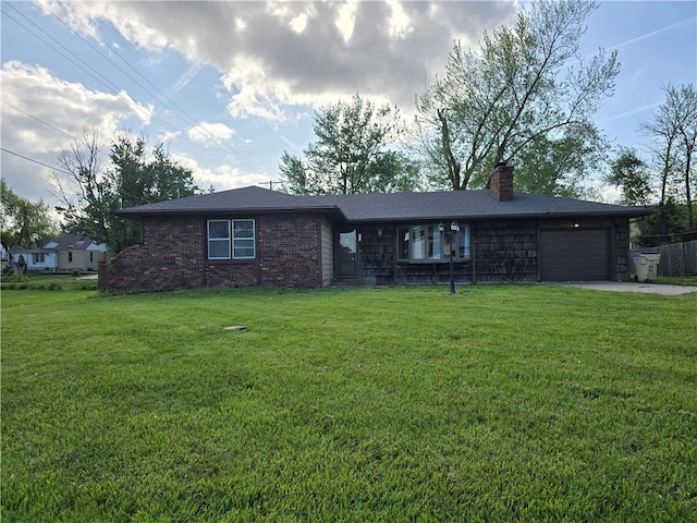 single story home featuring a garage, a chimney, a front yard, concrete driveway, and brick siding