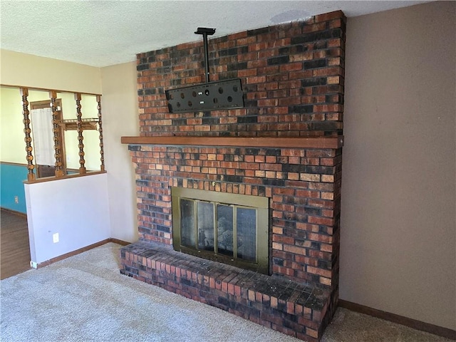 carpeted living area with a fireplace, baseboards, and a textured ceiling