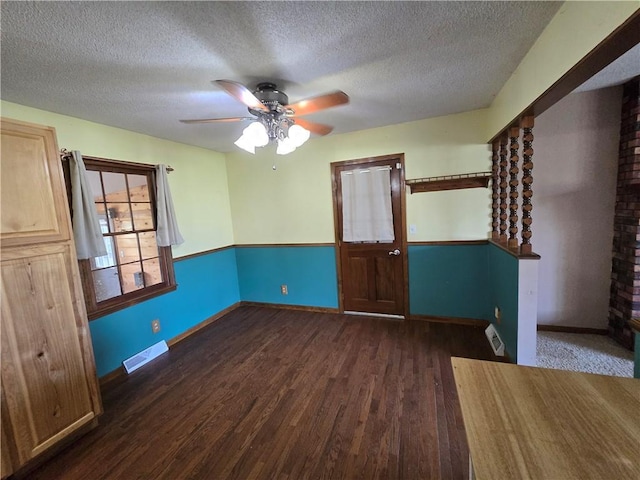 empty room featuring wood finished floors, a textured ceiling, a ceiling fan, and baseboards