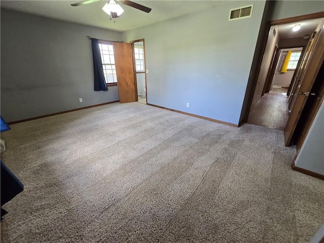 spare room with a ceiling fan, baseboards, and healthy amount of natural light