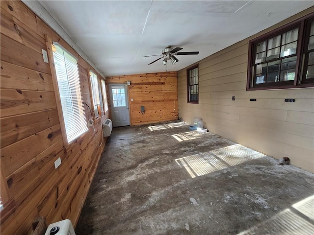 unfurnished sunroom with an AC wall unit