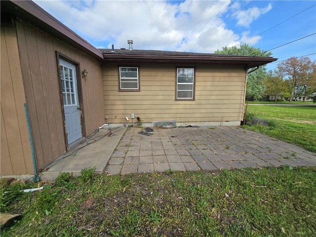 rear view of house with a patio area and a lawn