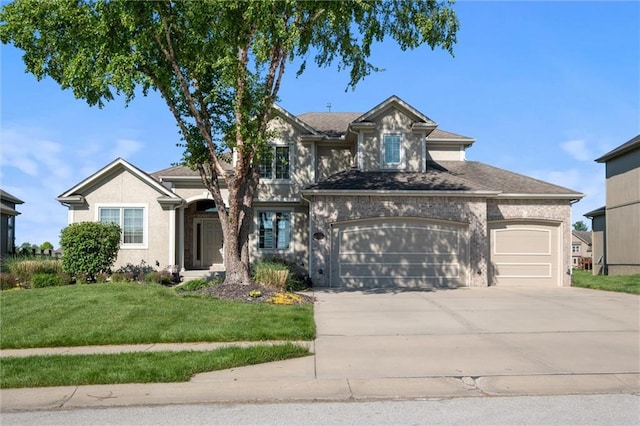 traditional-style home featuring driveway, a front lawn, an attached garage, and stucco siding