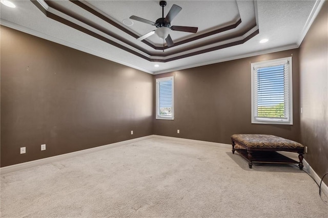 living area featuring crown molding, carpet floors, baseboards, a raised ceiling, and recessed lighting