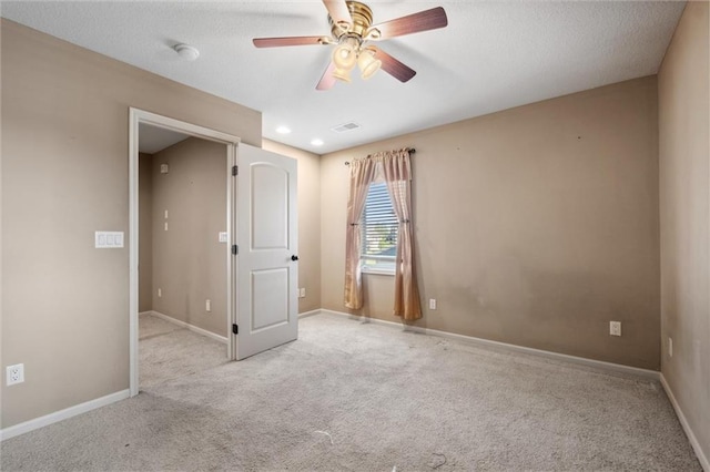 empty room featuring carpet floors, a ceiling fan, and baseboards