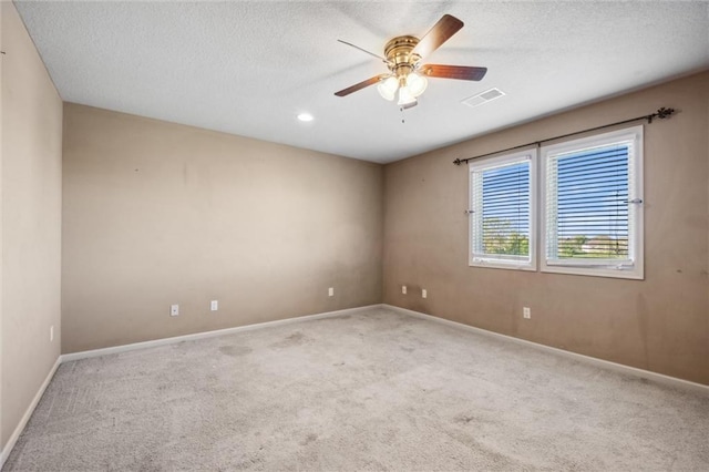carpeted empty room with a ceiling fan, baseboards, a textured ceiling, and recessed lighting