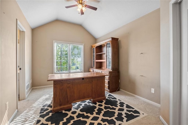 office area featuring ceiling fan, light colored carpet, lofted ceiling, and baseboards