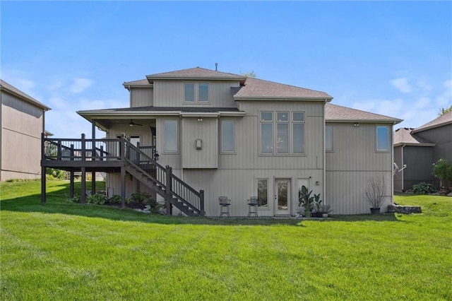 back of house featuring ceiling fan, stairway, a lawn, a deck, and roof with shingles