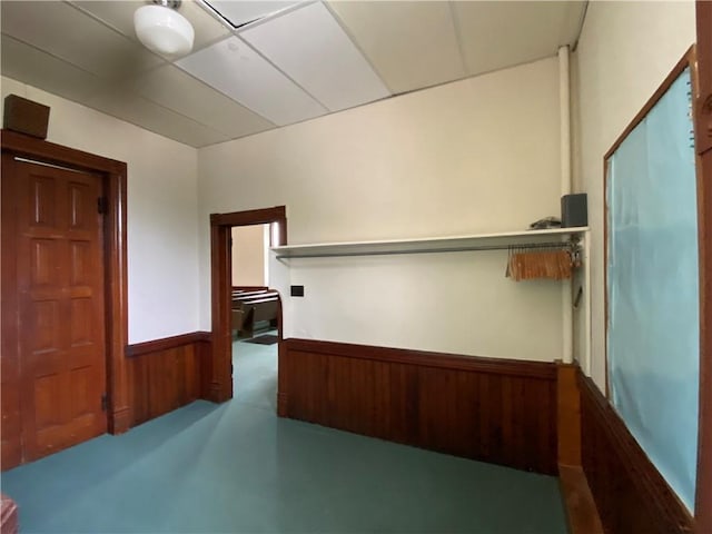 220 N 9th St, Atchison, KS 66002 - corridor featuring concrete flooring, a wainscoted wall, and wooden walls